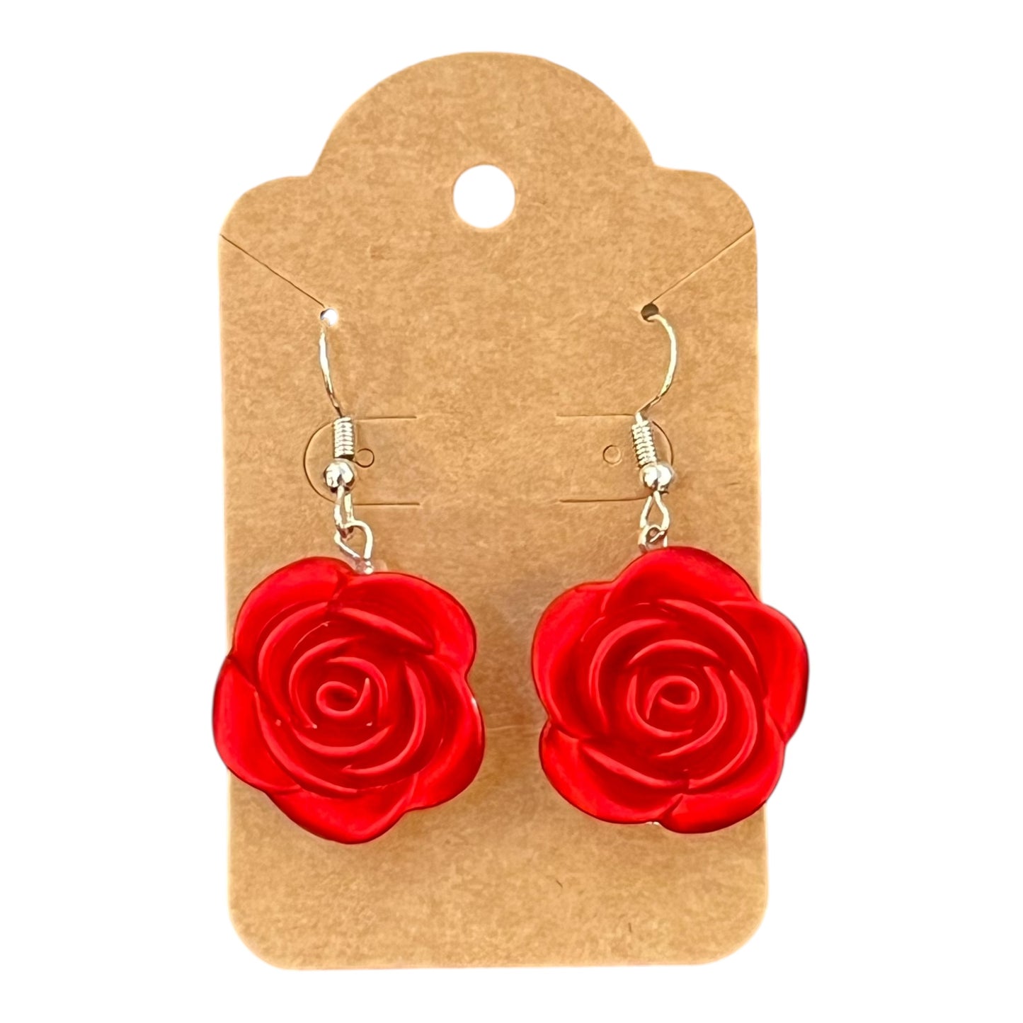 Red rose-shaped earrings on a JenDore brown earring card against a white background