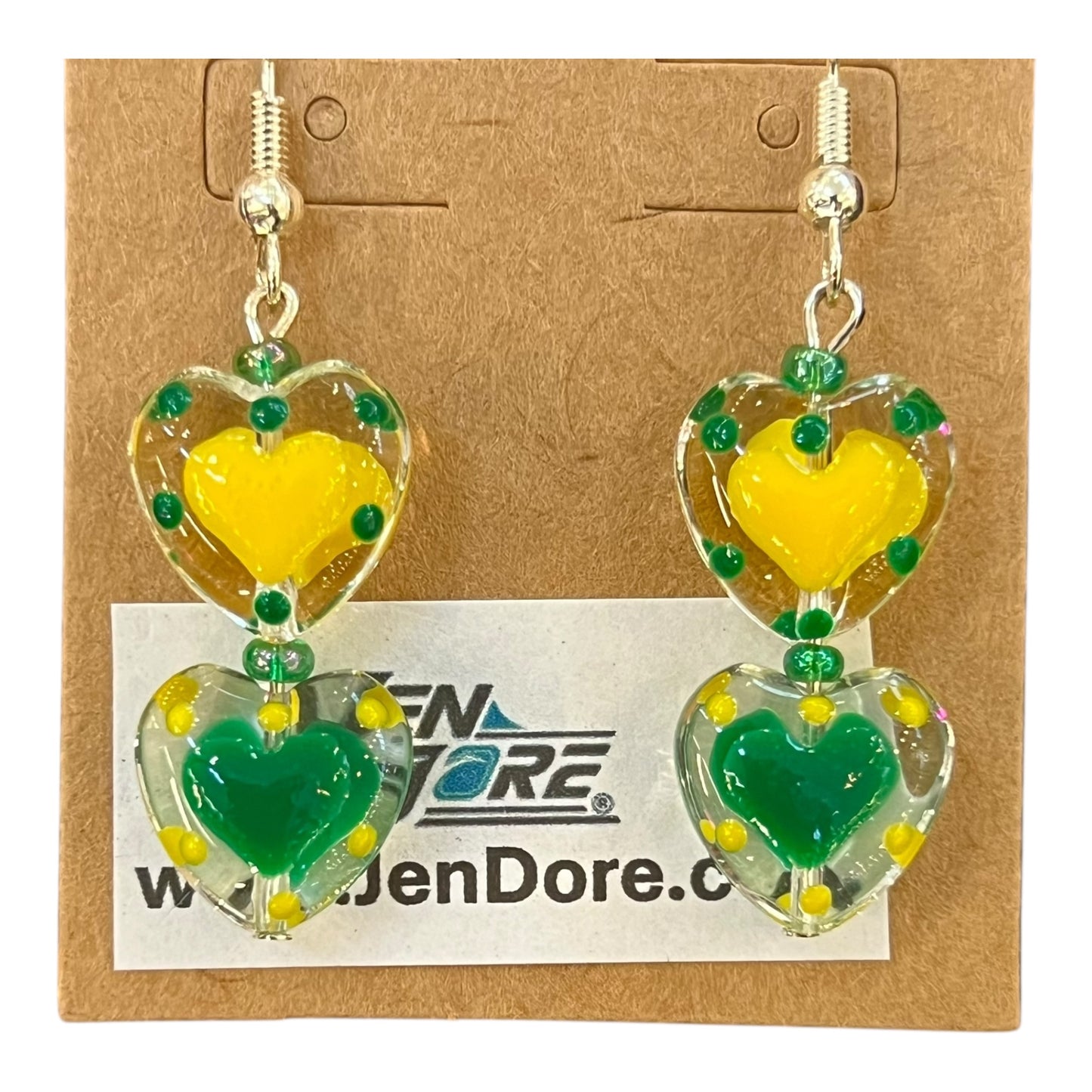 Heart-shaped earrings with yellow and green hearts on a JenDore card.
