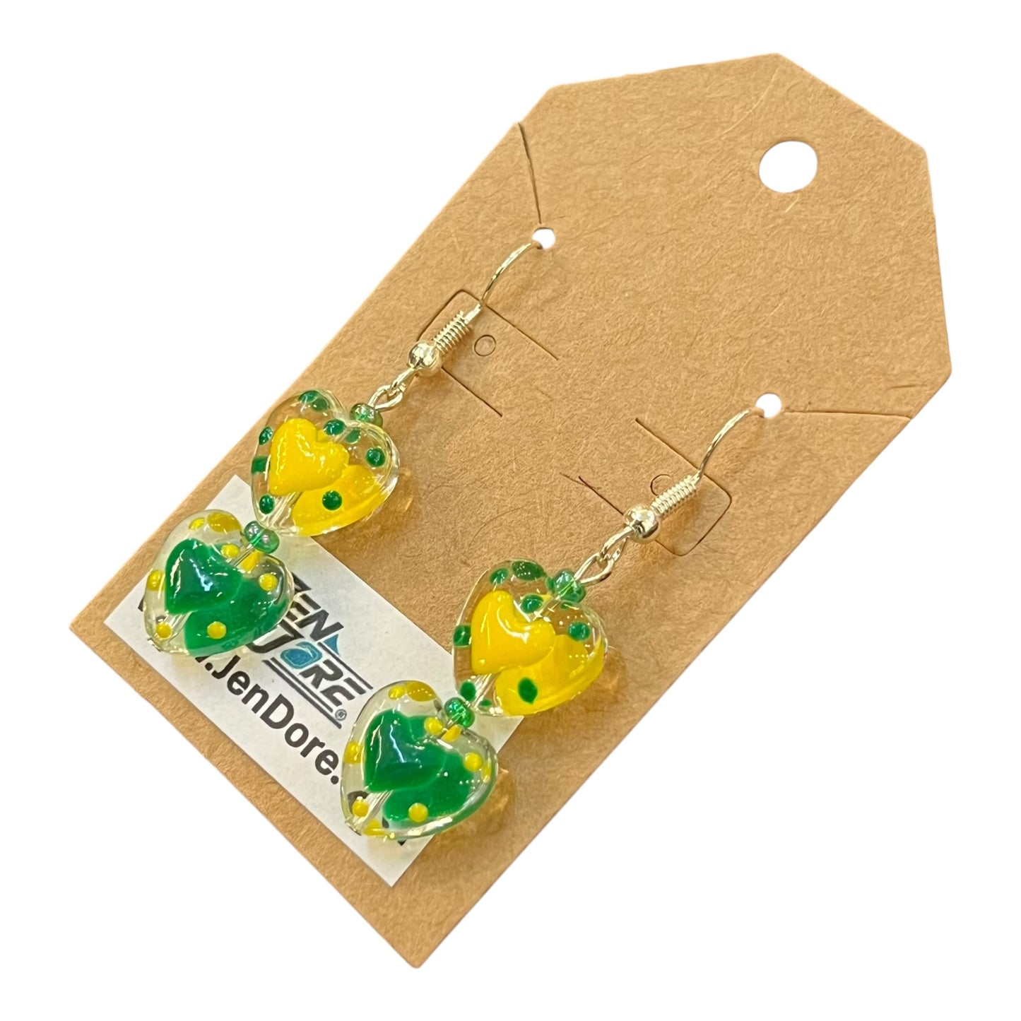 Heart-shaped earrings with green and yellow details on a JenDore brown card with a brand label.