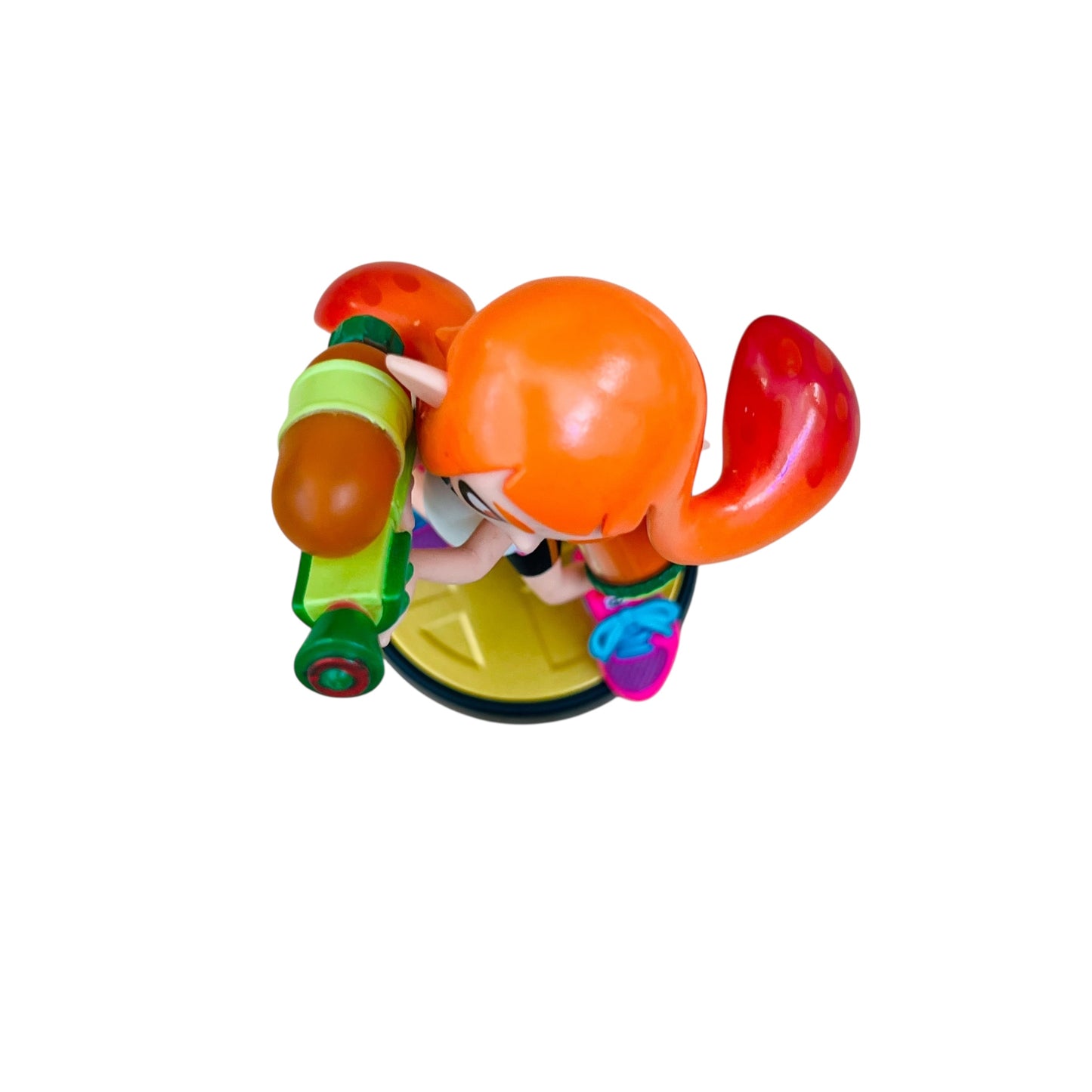 Colorful figurine with an orange head and red hair on a white background