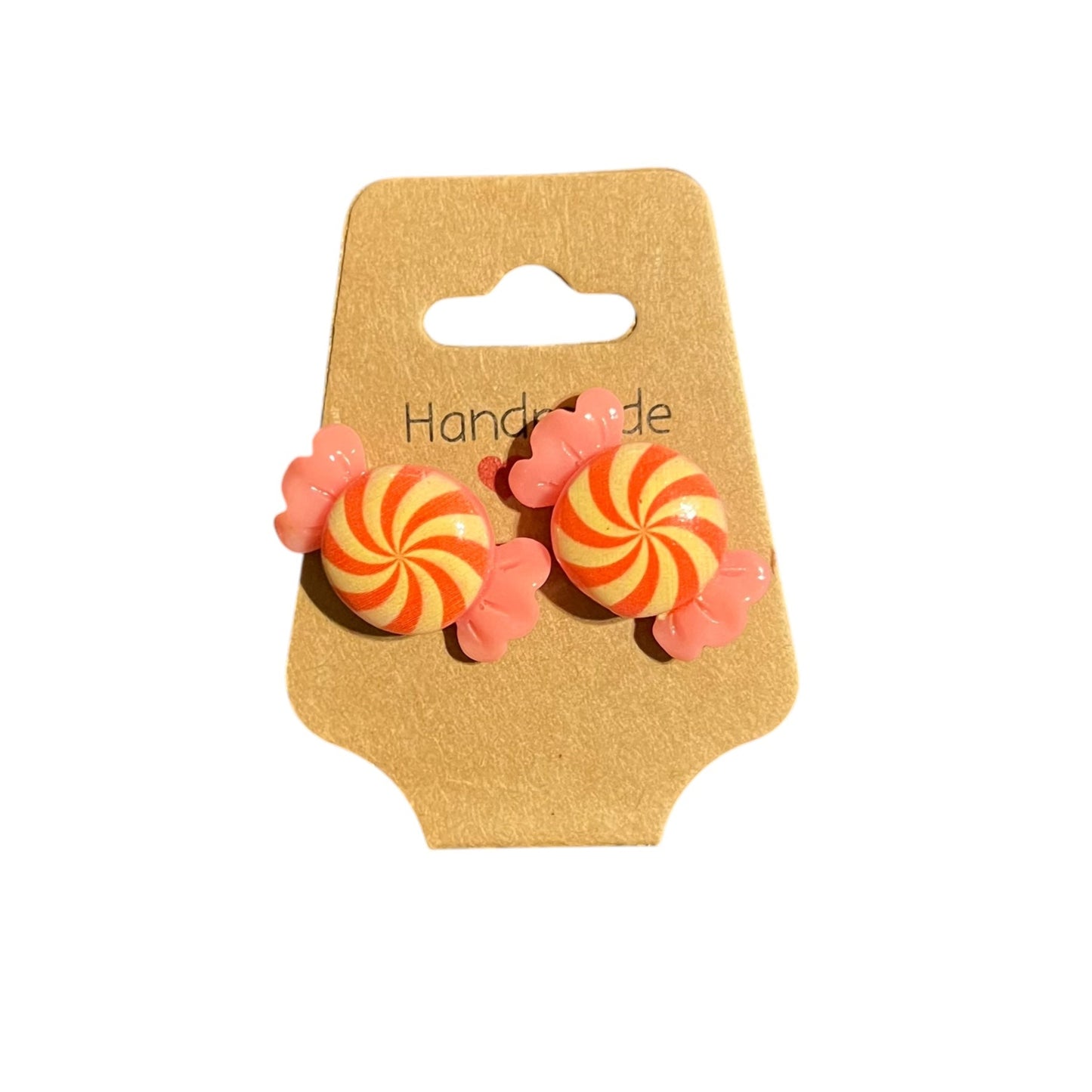 A pair of handmade coral yellow candy swirl stud earrings on a cardboard hanger with the text 'Handmade'.