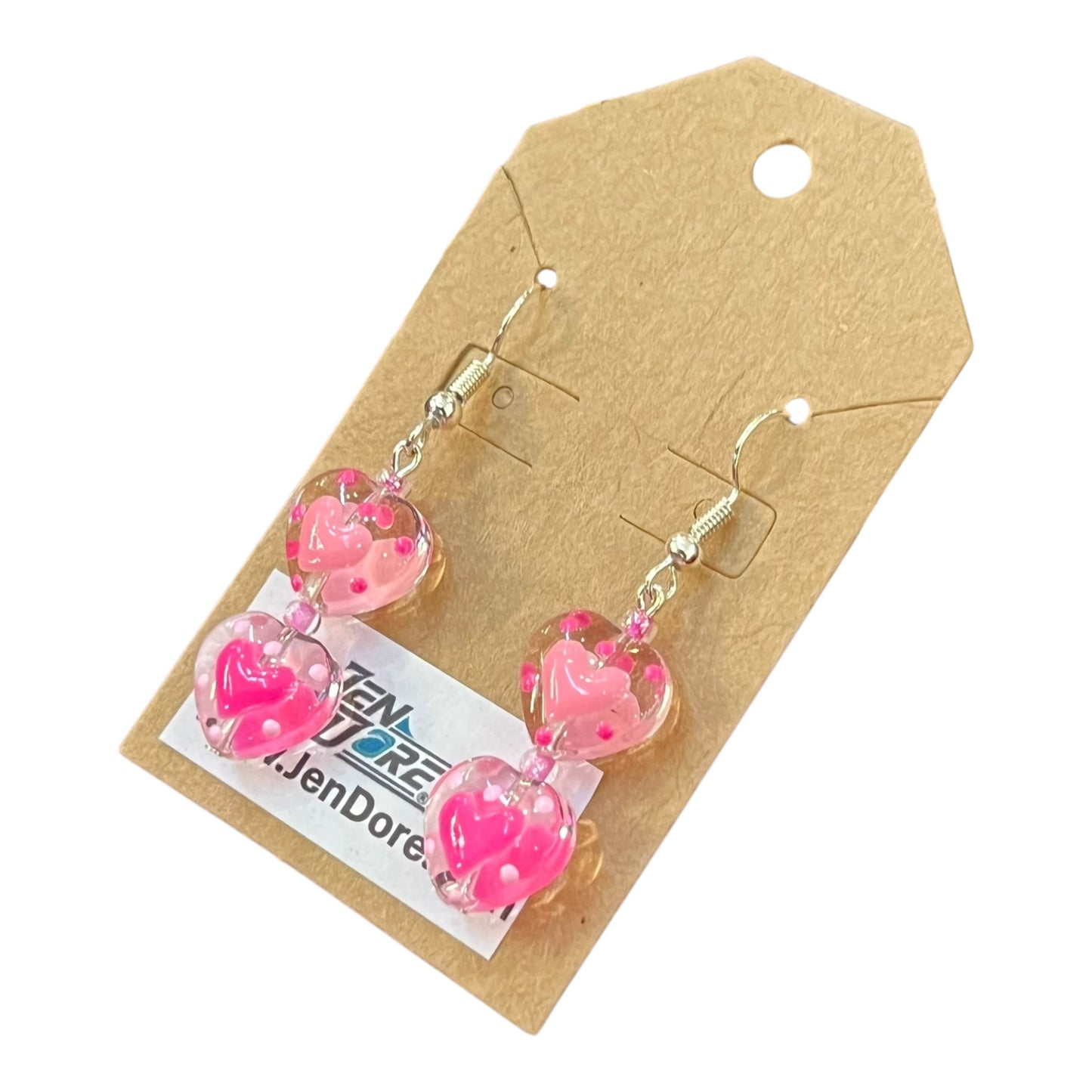 Pink heart earrings on a JenDore branded card