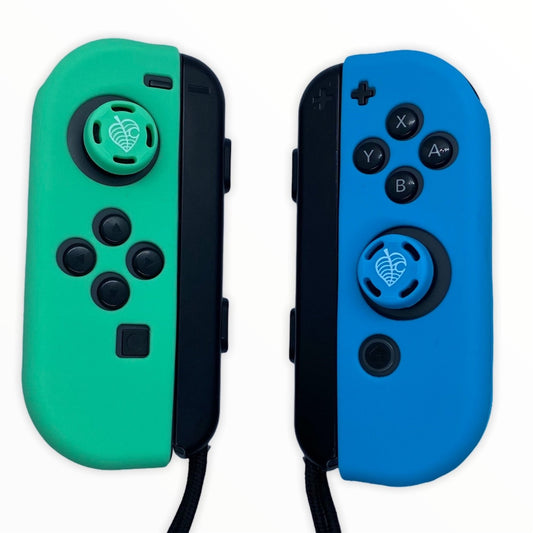 JenDore Juego de fundas protectoras Joy-con de silicona azul y verde para Nintendo Switch y empuñaduras para pulgar