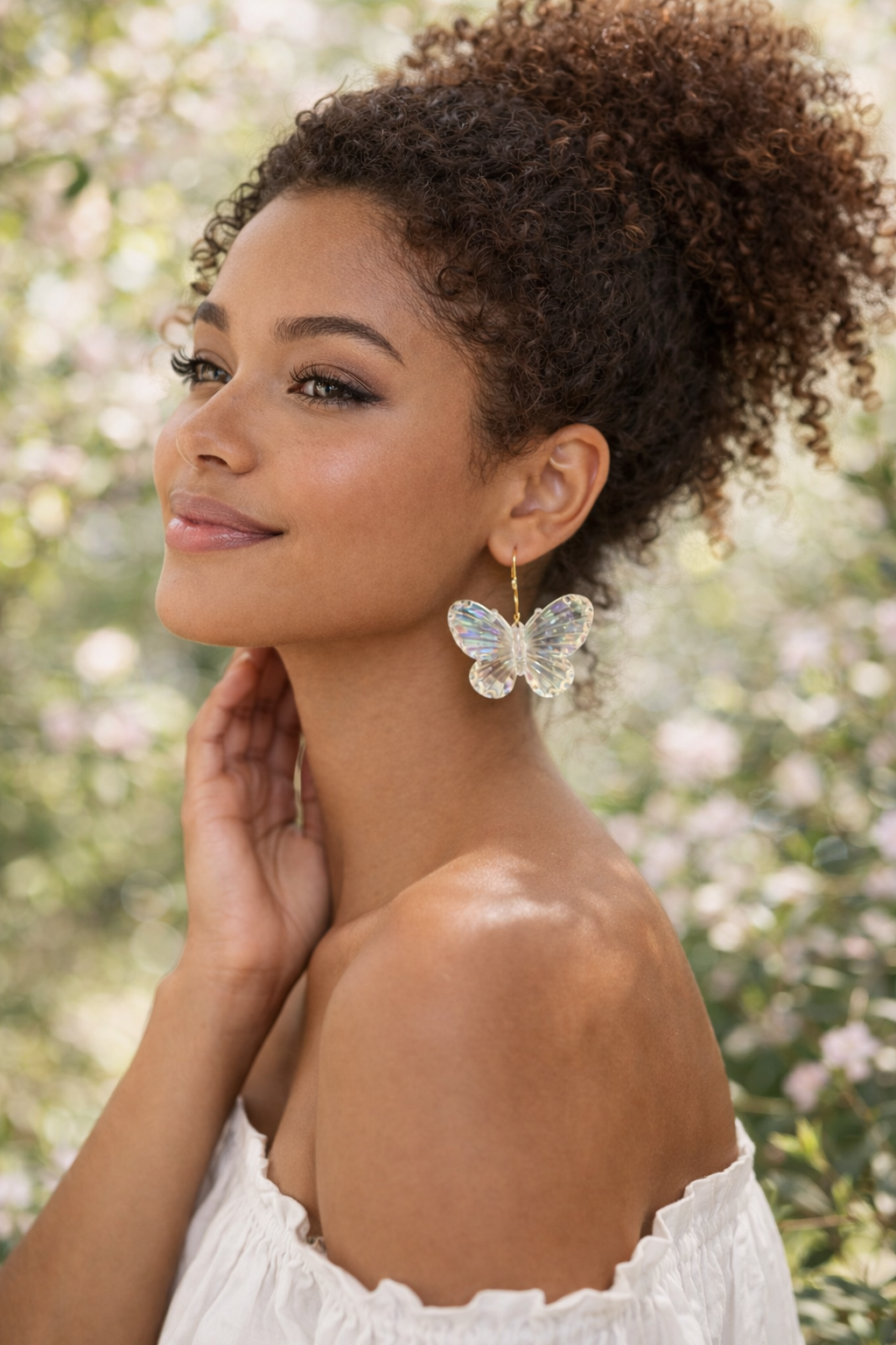 Woman wearing iridescent butterfly earrings in a lifestyle setting, handmade statement earrings by JenDore