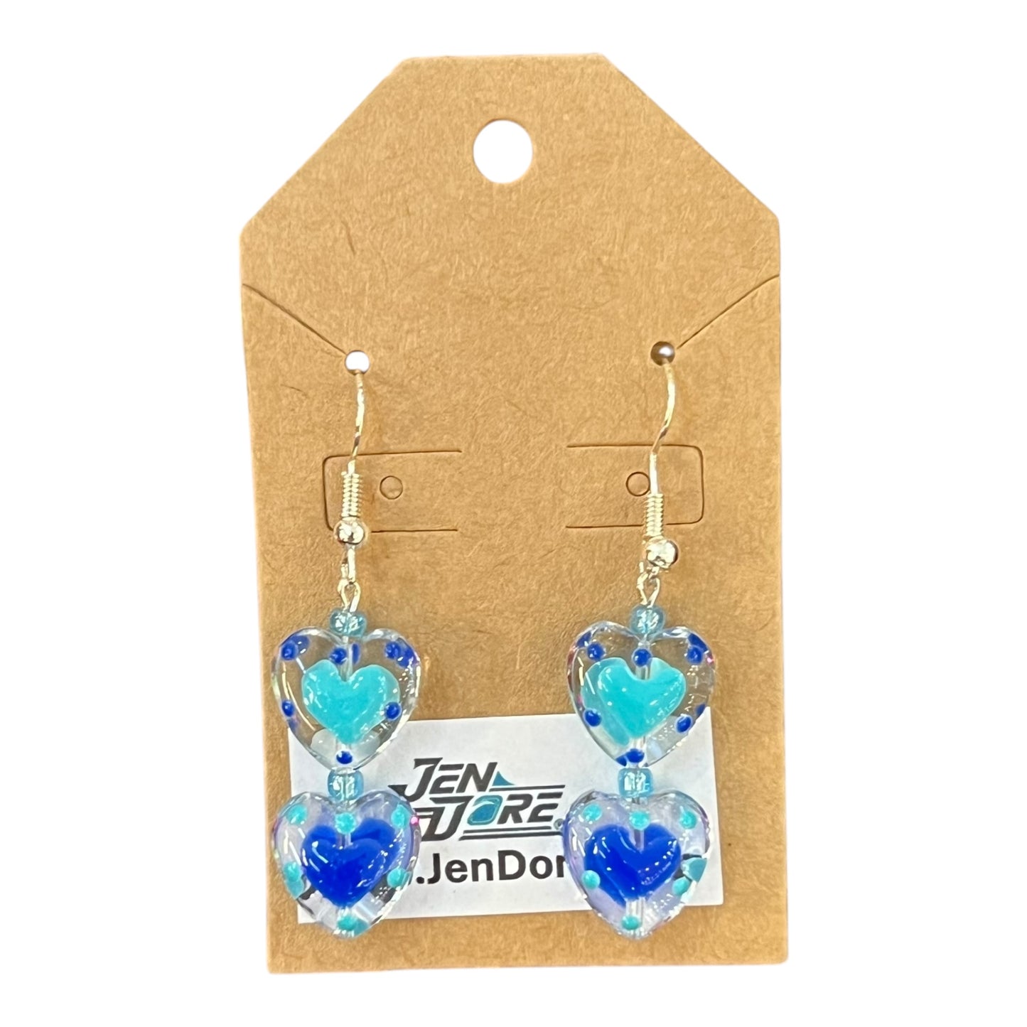 Heart-shaped earrings with blue and turquoise design on a JenDore branded card.