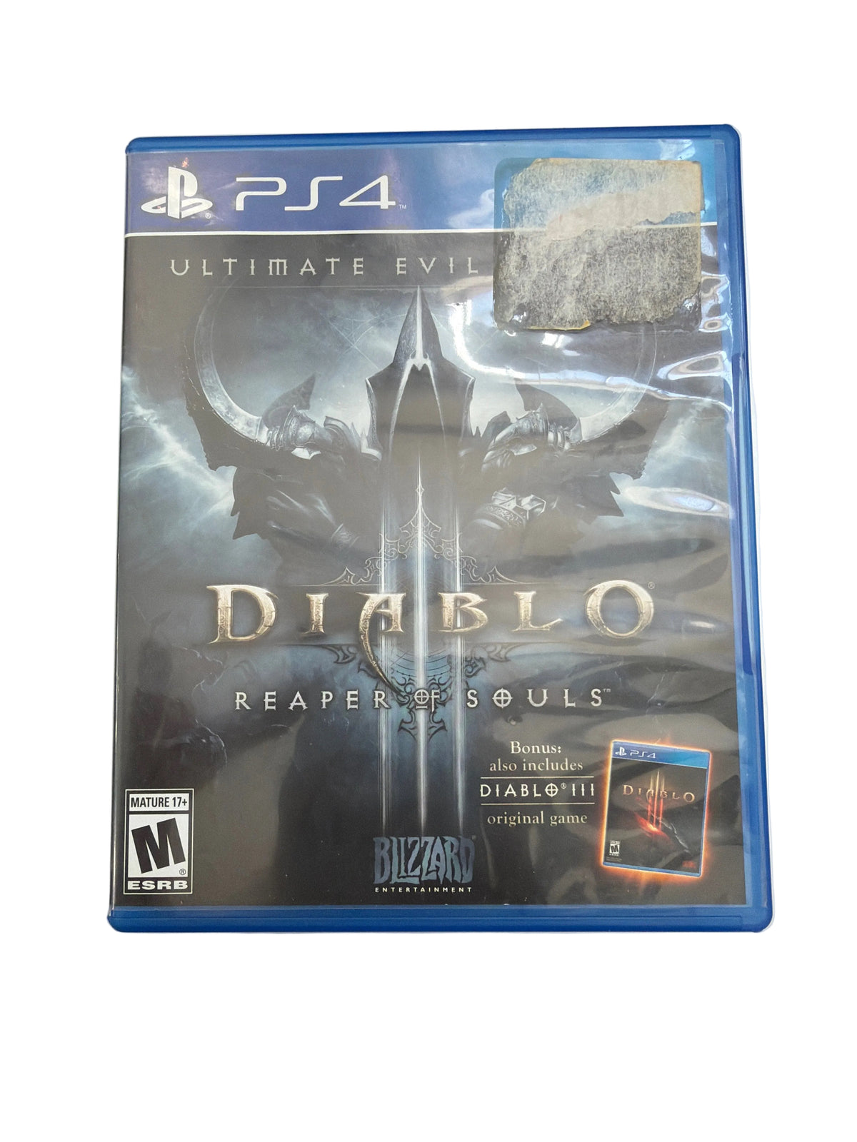 A PlayStation 4 game case for Diablo: Reaper of Souls, sealed in plastic shrink wrap, placed on a light-colored surface with a cutting mat visible in the background.
