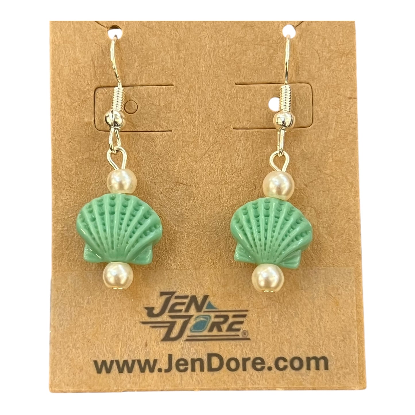 Pair of earrings with green shell and pearl design on a JenDore branded card.
