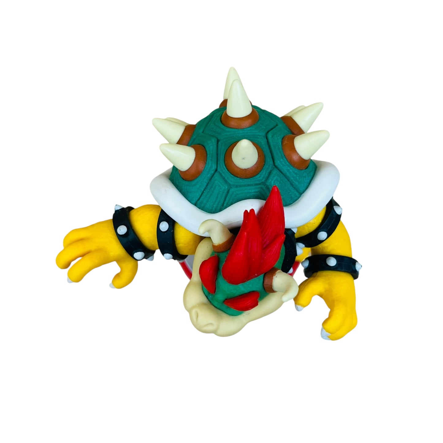 Colorful toy figure with a green shell, yellow limbs, and red mouth on a white background