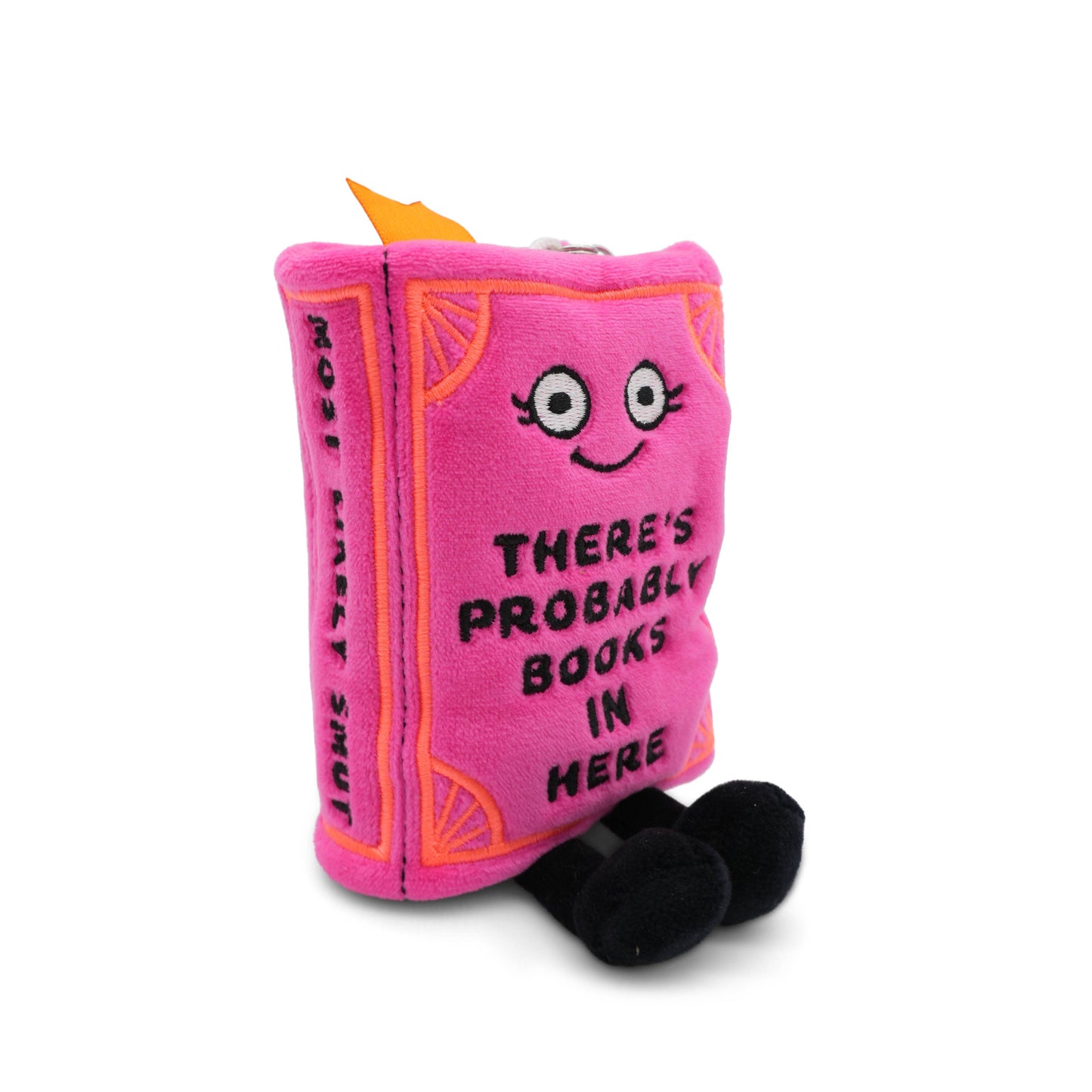 Pink plush toy shaped like a book with a face and text on a white background