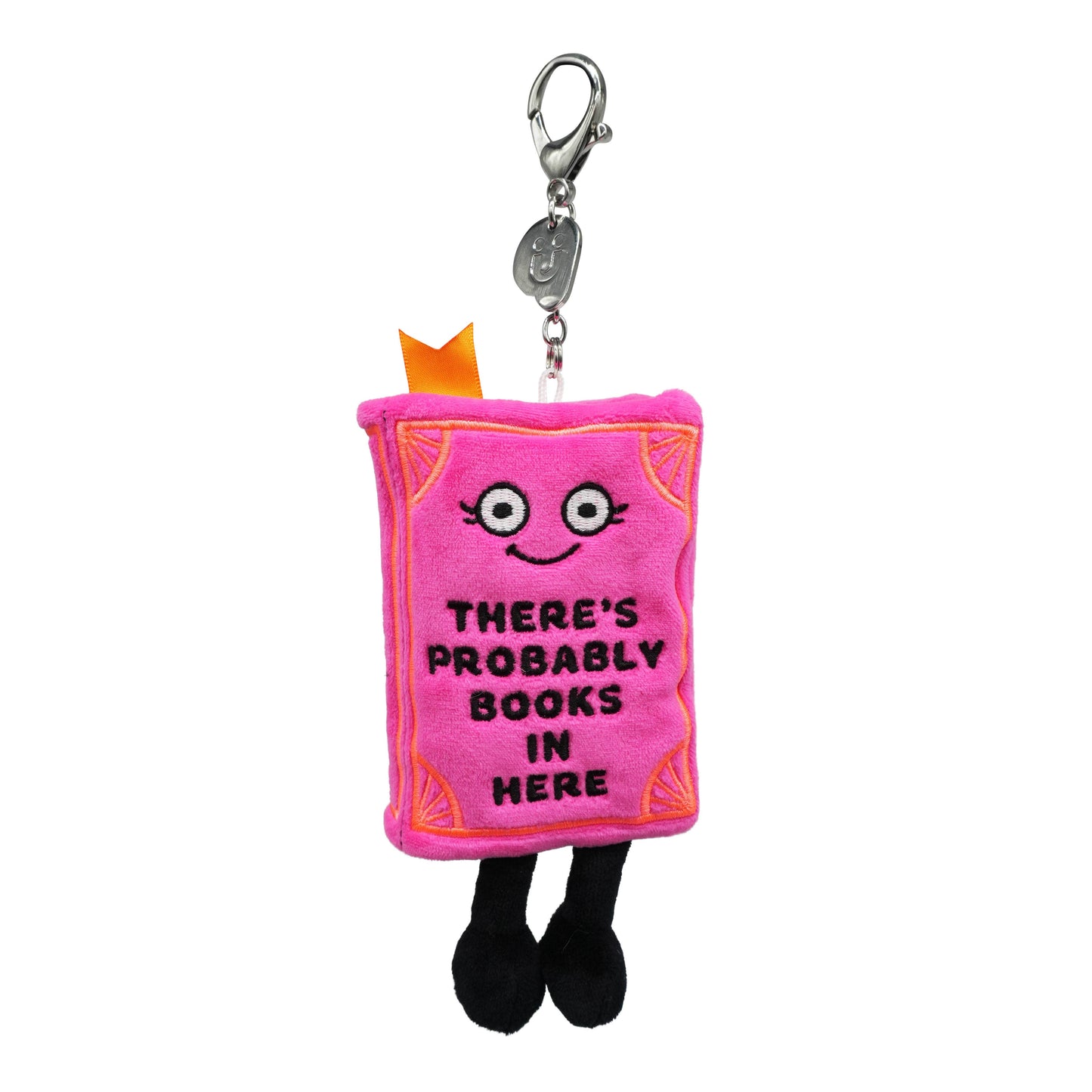 Pink plush keychain shaped like a book with text and a smiling face on a white background